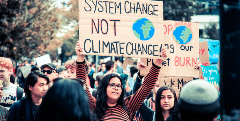 Two young women protesting for action against climate change
