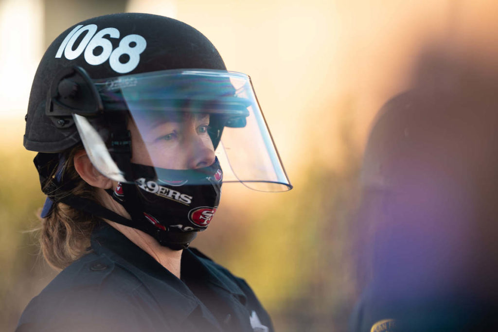 A female police officer wears a 49ers mask in San Francisco