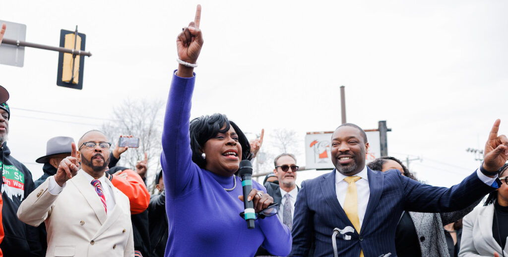 Mayor Cherelle Parker, center, holds up her "One Philly" finger during an event. Photo by Quinton Davis.